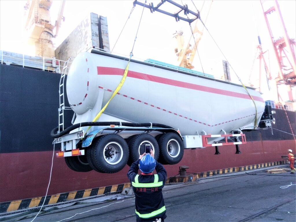 ZW Group bulk powder tanker trailer loaded at port for international shipment, ready for cement, flour, and powder transport