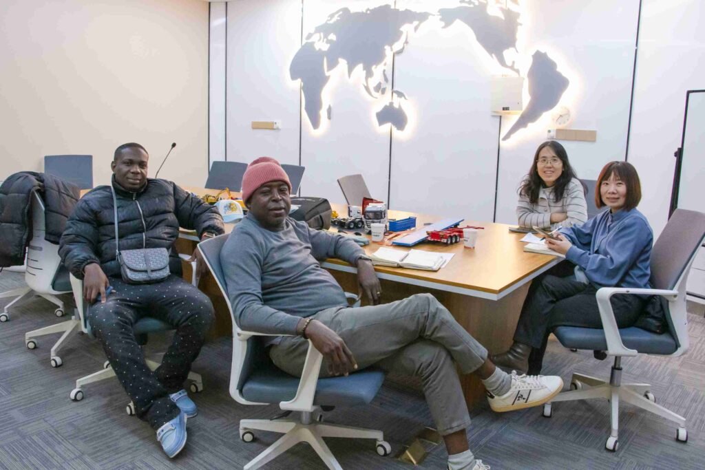 Nigeria client and ZW Group team taking a group photo after discussing HOWO truck and fuel tanker semi-trailer purchase cooperation