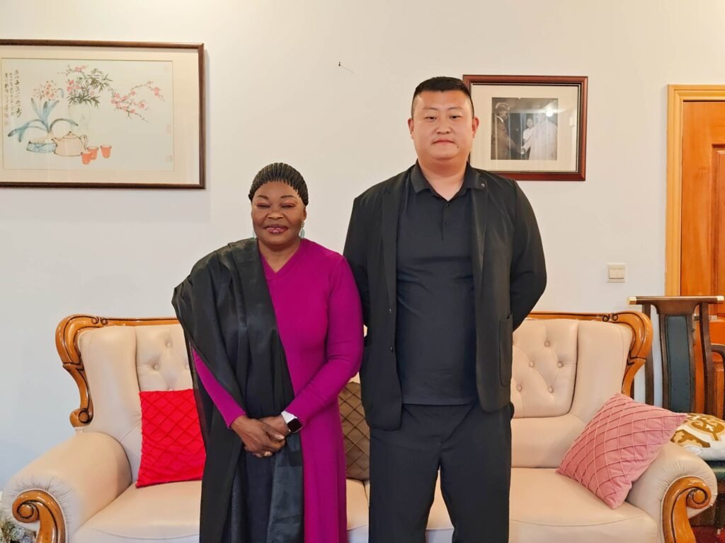 General Manager Pierce Guo with Guinean Ambassador Aminata Koita discussing heavy-duty mining trailer solutions.