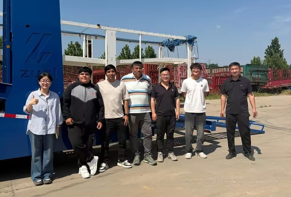 Peruvian logistics delegation poses with ZW Group team during factory inspection for custom fuel tankers and car carrier trailers.